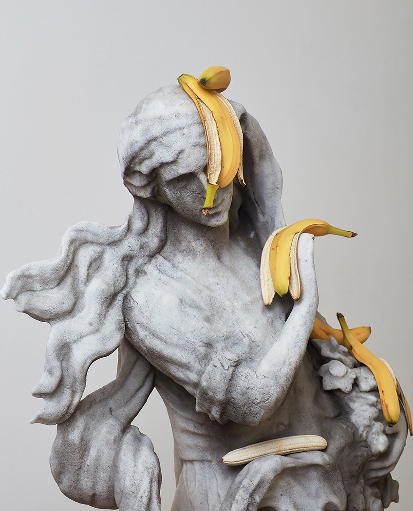 A marble figure draped with banana peels